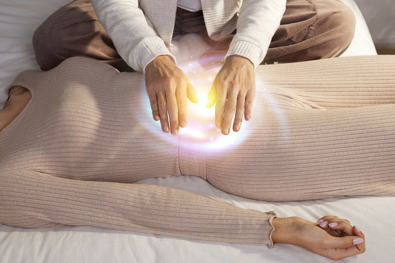 Photo of a therapist helping a woman with Reiki energy healing