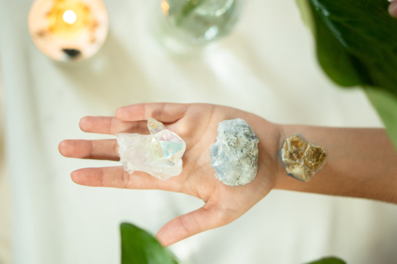 Large crystal quartz stones in the palm of the hand.