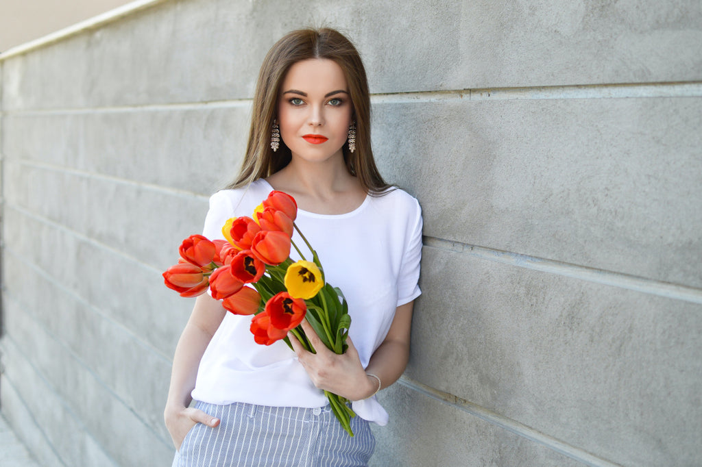Model carries a bouquet of tulips.