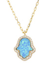 A close up of the Hamsa Opalite Turquoise Blue Gold Necklace against a white background.