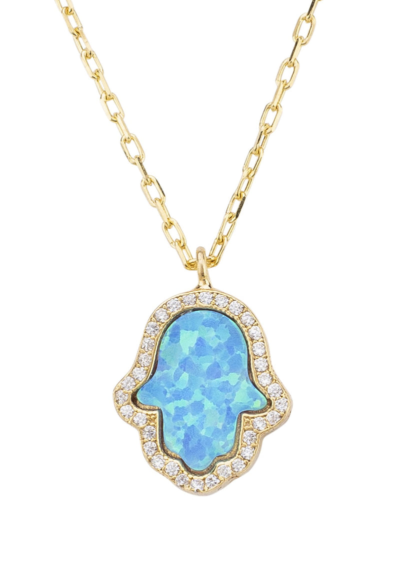 A close up of the Hamsa Opalite Turquoise Blue Gold Necklace against a white background.