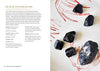 The book Crystals for Beginners has been opened to Black Tourmaline stones. A picture of the stone is visible along with the accompanying text.
