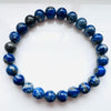 Lapis Lazuli 8mm crystal bracelet against a white background.