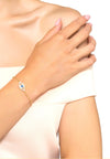 Model is wearing the evil elliptical bracelet in blue with a rosegold finish. 