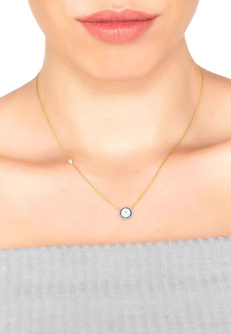 A model wears the evil eye mother gold necklace. This picture allows you to see the actual size and length of the necklace.