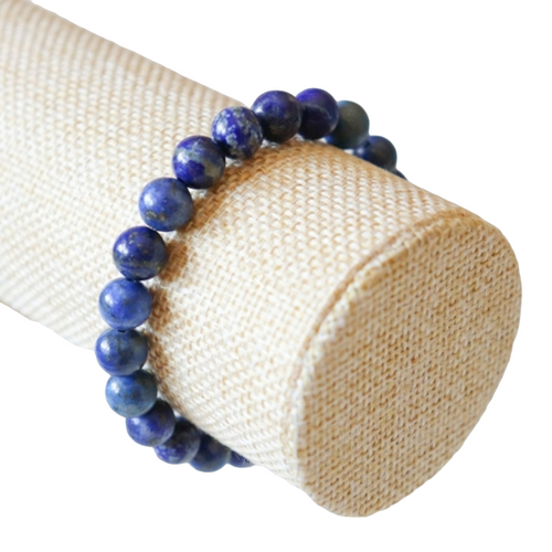 8mm Lapis Lazuli gemstone bracelet on a bracelet holder.